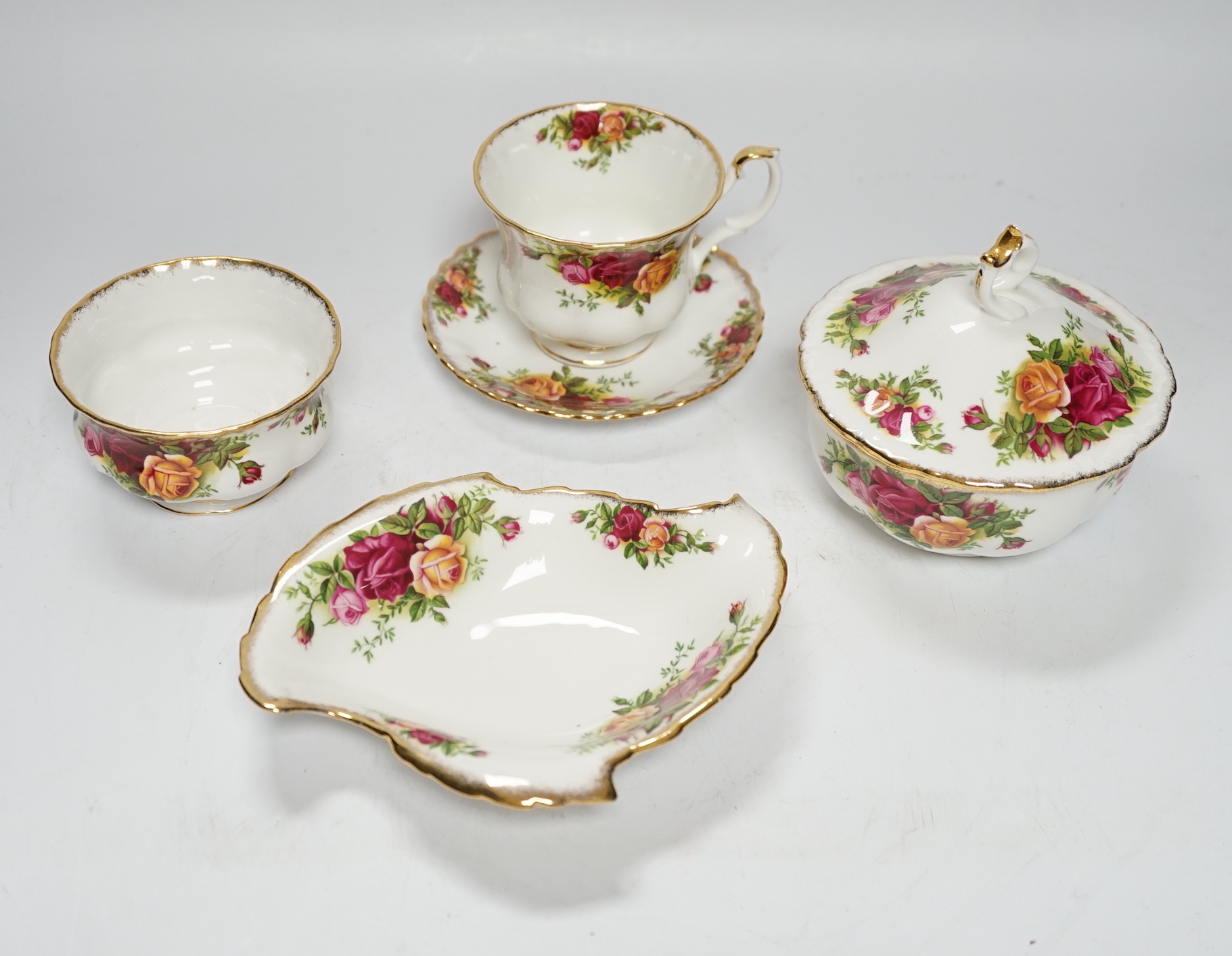 A quantity of Royal Albert old country roses pattern teawares including teapot, various cups and saucers, side plates, cake stand, coffee, pot, quartz, clock, sugar bowl, trays, etc.